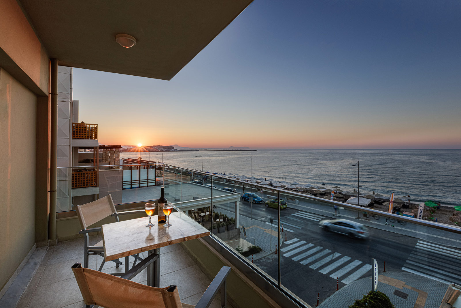 Hotel Balcony by sunset, table of wine with sea view